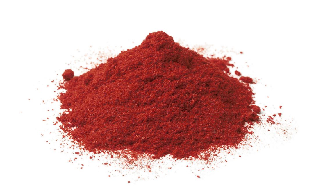 Red powder on white background - astaxanthin